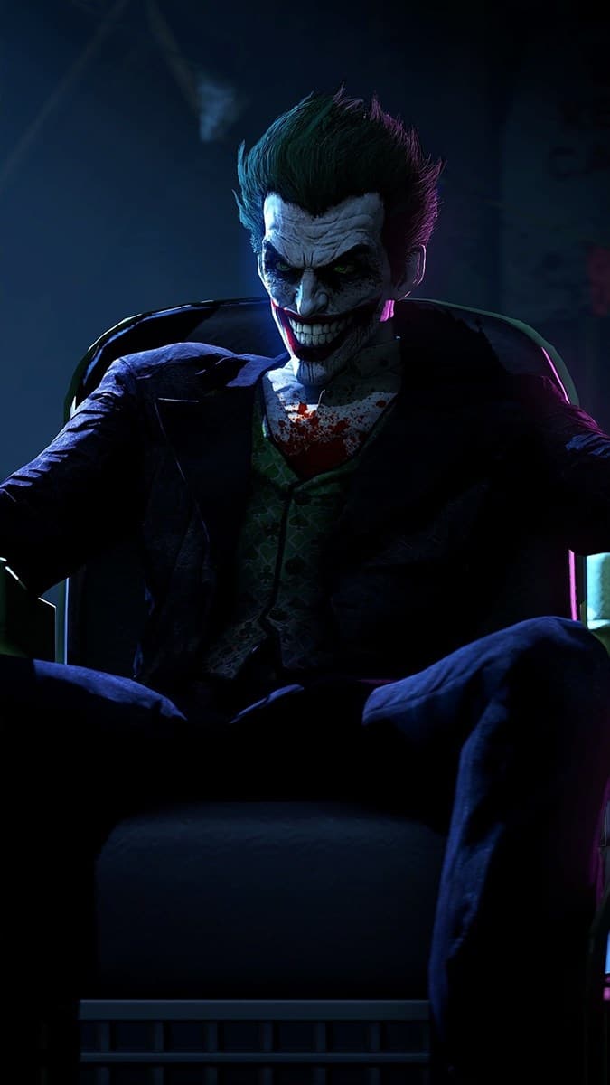 Hình nền Joker đang ngồi cười man rợ.