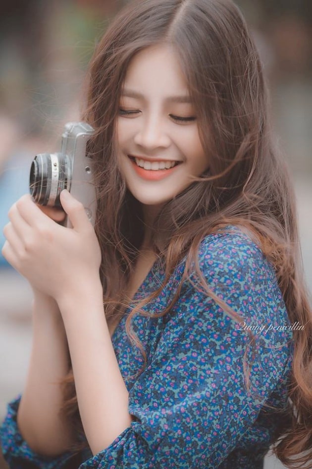 Hình ảnh gái xinh cười tạo dáng với chiếc máy ảnh.